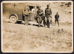 Photograph of small group of Irish Brigadiers beside vehicle with James Roche