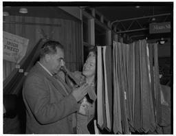 Miss Gracie Fields visiting Shannon Airport, pictured at the Irish tweed counter with a man