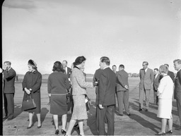 Brendan O'Regan, Mr Lynch and Mr Quigley greeting woman