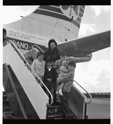 Family at plane steps