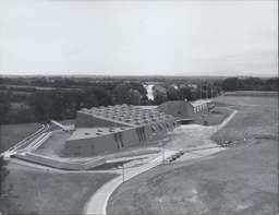 [View of NCPE building with playing fields in background.]