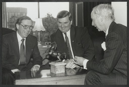 Ray MacSharry, Dr Ed Walsh and two unidentified men at Plassey House with a small statue of a rearing horse