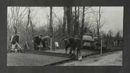 workers laying out a roadway