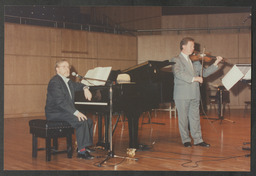 Pat Kelly, Dr Ed Walsh, Leo Colgan and others giving a musical performance on stage in the University Concert Hall