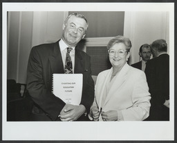 Niamh Breathnach, Minister for Education, with a man holding a white paper on education entitled "Charting Our Education Future"