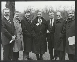 Group of men in overcoats standing outdoors