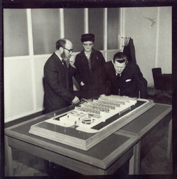 Mr. Brendan O'Regan, Mr. Hudson and his son, with model of factory