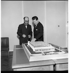 Mr. Brendan O'Regan, Mr. Hudson and his son, with model of factory