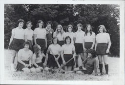 [Group portrait of TCE camogie team with coach.]