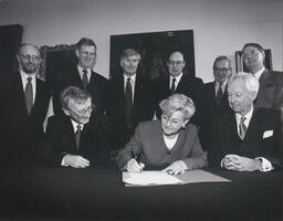 The heads of the 7 universities with the Minister for Education Niamh Bhreathnach signing the commencement order for the Universities Act at NUI Maynooth