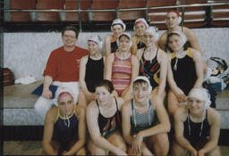 [Group portrait of TCE female swimming team with coach.]