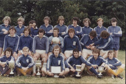 [Group portrait of TCE Gaelic football team with various trophies and cups.]