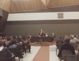 [Member of Governing Body addressing audience at TCE graduation ceremony.]