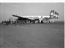 Pipers on St. Patrick's Day on Tarmac, Near Airplane