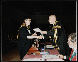 UL President Robert Downer presents distinguished performance gold and silver medals to graduates