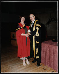 UL President Robert Downer presents distinguished performance gold and silver medals to graduates