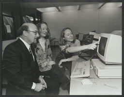 Tom Coffey with two students seated at a computer