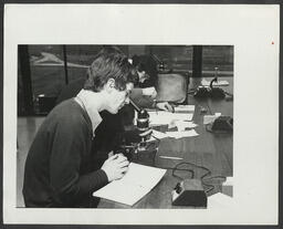 Students and teachers using microscopes