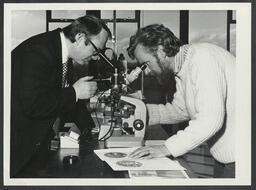 Students and teachers using microscopes