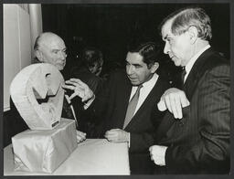 Three men viewing a sculpture at an Irish Peace Institute Event