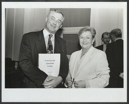 Niamh Bhreathnach, Minister for Education, with a man holding a white paper on education entitled "Charting Our Education Future"