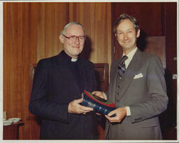 Bishop of Limerick Jeremiah Newman presenting a copy of his book "Maynooth in Georgian Ireland" to Dr Ed Walsh for the NIHE library