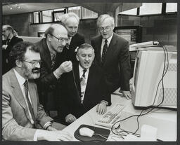 Kevin Ryan, Tom Coffey, Cyril Burkley, Dr Ed Walsh and an unidentified man looking at a computer screen