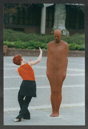 Woman dancing around Anthony Gormley's statue  "Together and Apart" on the Plaza