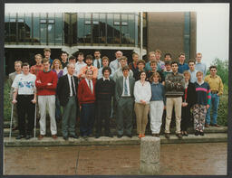 A group photo of students and Tim McGloughlin in front of the Main Building at the University of Limerick