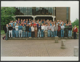 A class photo of students and Tim McGloughlin in front of the Main Building at the University of Limerick