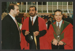 Graduation shots, individual sitting at office desk