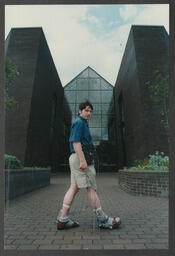 A student demonstrating technical sensory equipment "Earthquake machine" outside the Foundation Building at the University of Limerick